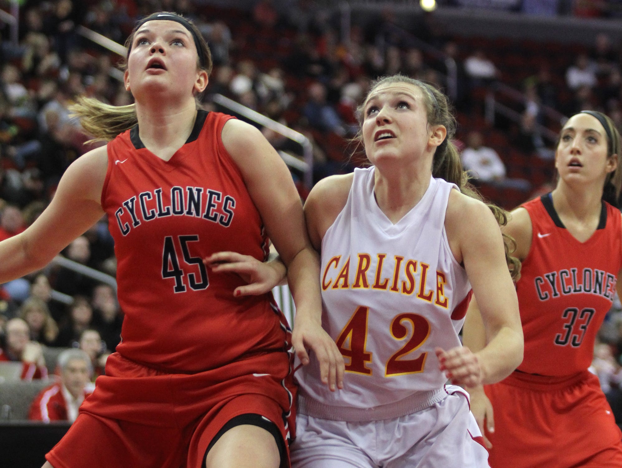 Harlan's Taylor Frederick and Carlisle's Agatha Beier fight for position on a rebound in a Class 4-A semifinal at Wells Fargo Arena in Des Moines last season. Carlisle lost to top-ranked Harlan 69-43.