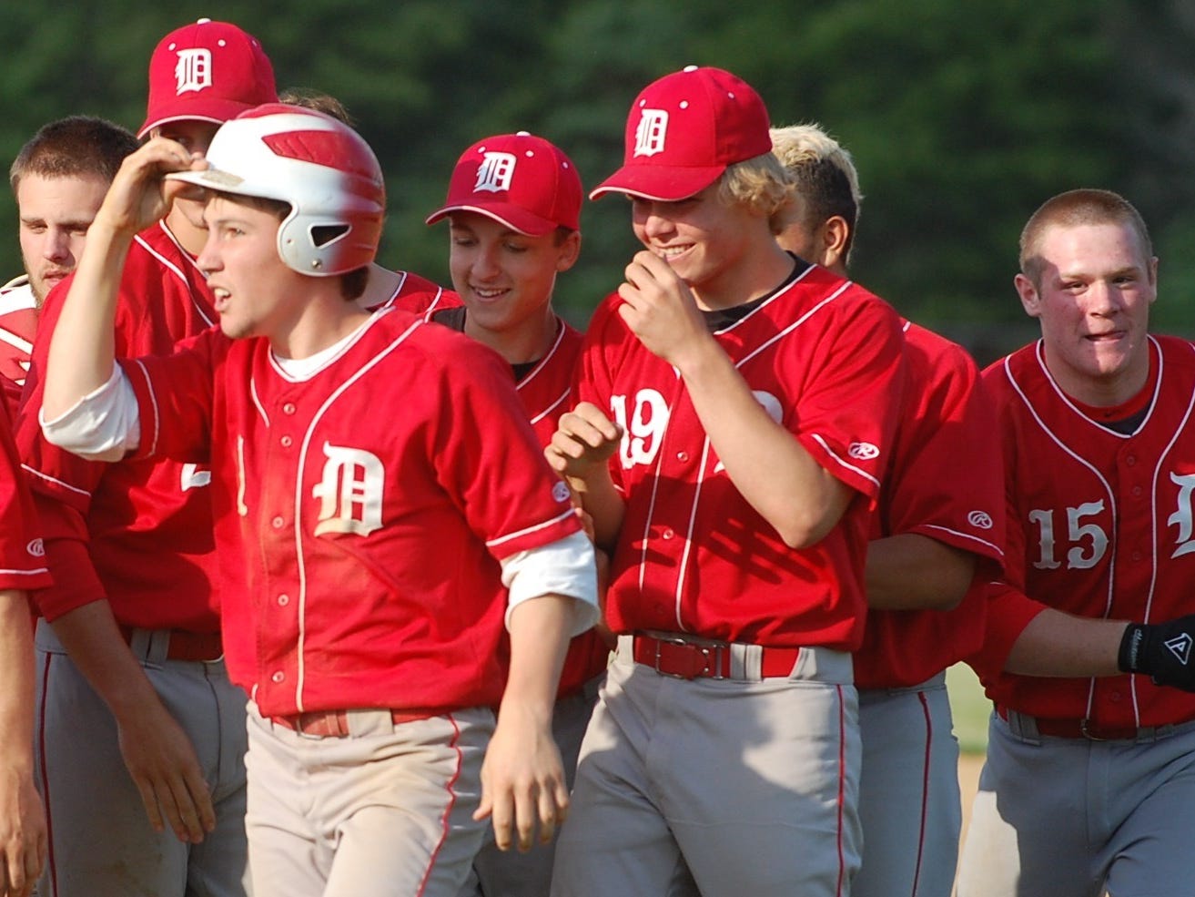 Delsea celebrates after Tom Carney (with helmet) was hit by a pitch Friday to drive in the winning run.