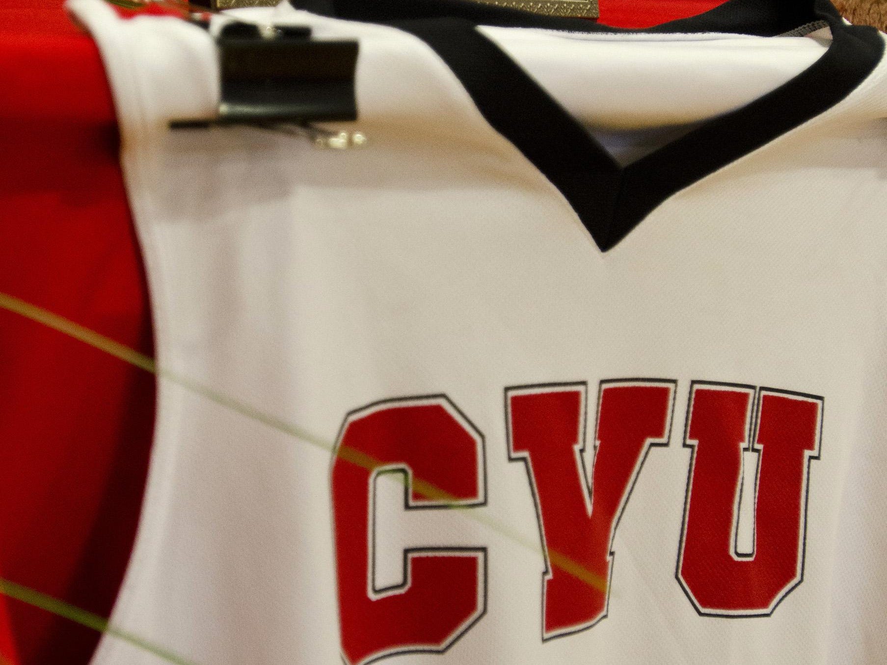 A photo of Kevin Riell, the Champlain Valley activities director who died unexpectedly last year, rests above a basketball jersey during a memorial service in January.