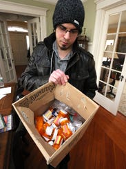 Andrew Greenspan with a box of medications he has stopped