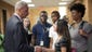 U.S. Attorney General Eric Holder  shakes hands with Bri Ehsan, 25, following his meeting with students at St. Louis Community College-Florissant Valley in Ferguson, Mo. Holder was in Ferguson to oversea the federal government's investigation into the shooting death of 18-year-old Michael Brown by a police officer on Aug. 9th.