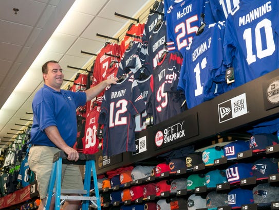 Ed Bush, owner of GameDay Sports, in his store in the