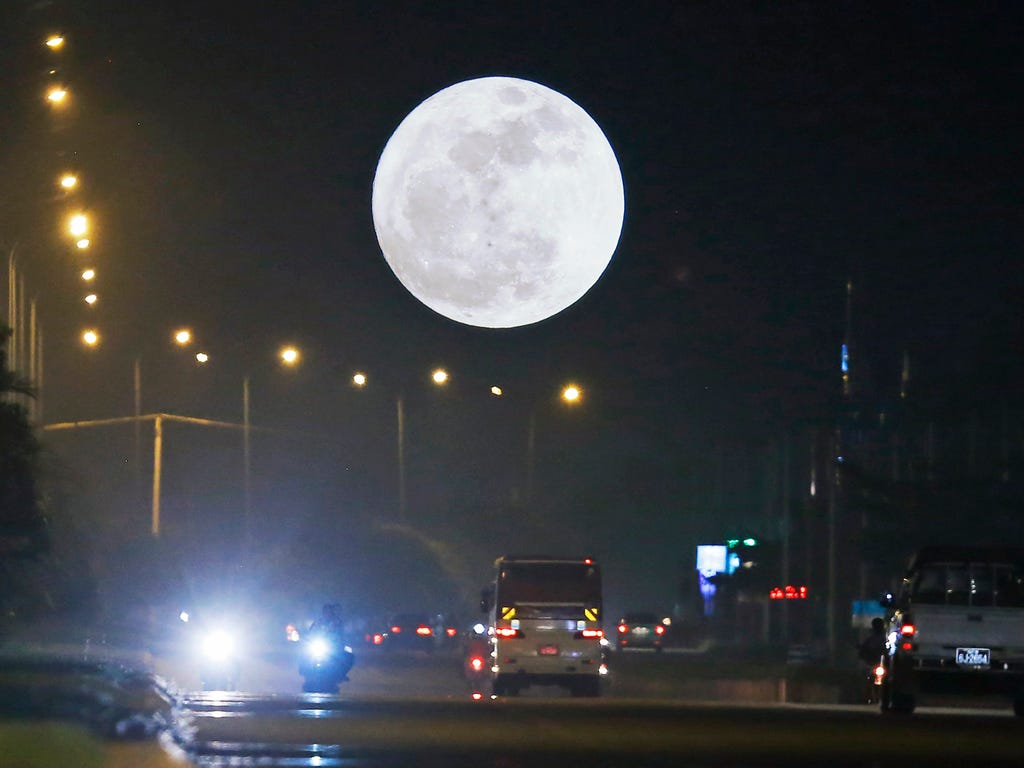 A Supermoon dominates the sky while traffic rolls in the streets in Naypyitaw, Myanmar on Dec. 3, 2017.  According to the National Aeronautics and Space Administration (NASA) a series of three 'Supermoons' - dubbed the 'Supermoon trilogy' - will appe