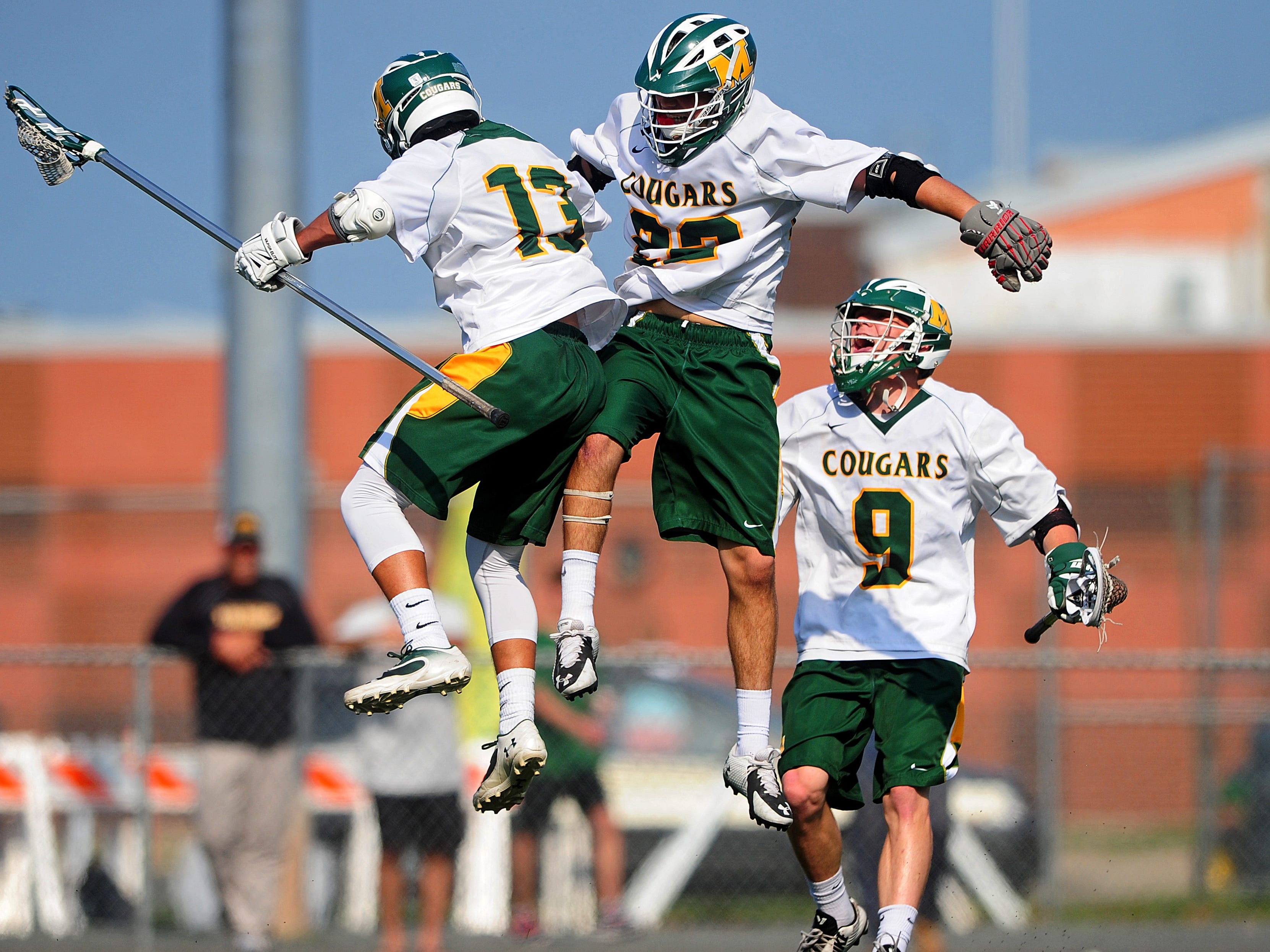 Lucas Goldoni, #13 of Montgomery, celebrates a buzzer-beating goal against Ridge in the first quarter with Matt Stagnitta, #22, and Cam Garinger, #9, during NJSIAA boys lacrosse first-round action on May 19, 2015 at Montgomery High School in Skillman, NJ. Will Schneekloth/Special to NJ State Media BRI 0520 BLAX Ridge at Montgomery