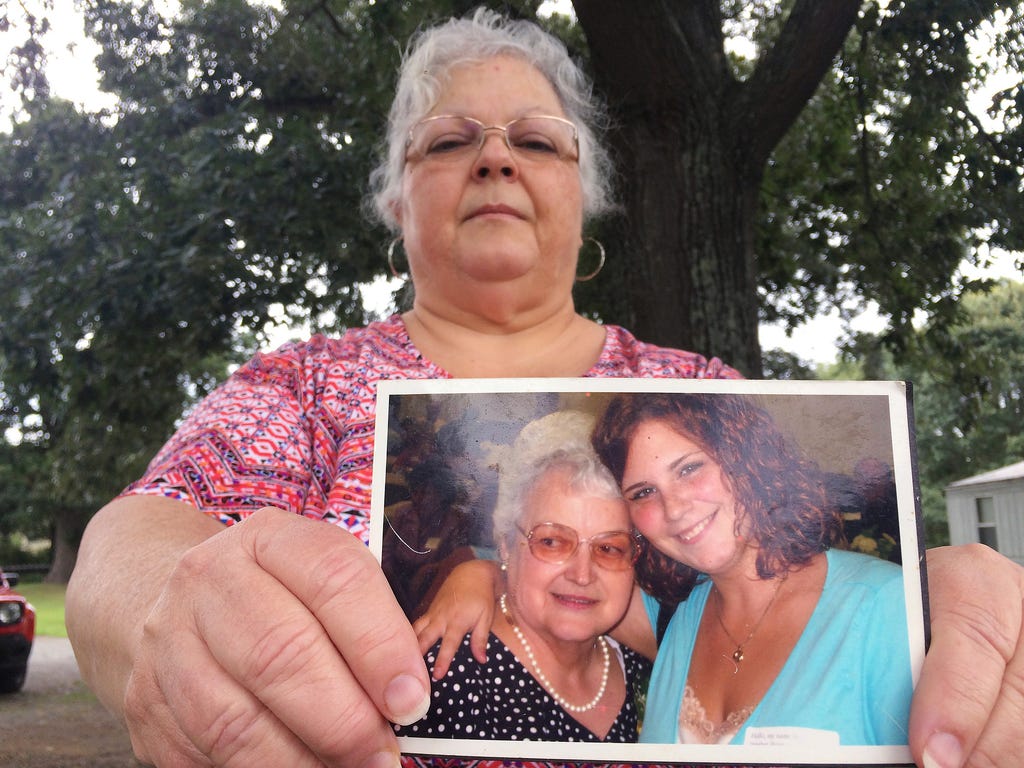 Susan Bro, the mother of Heather Heyer, holds a photo of Bro's mother and her daughter on Aug. 14, 2017, in Charlottesville, Va. Heyer was killed Saturday, Aug. 12, 2017, when police say a man plowed his car into a group of demonstrators protesting t