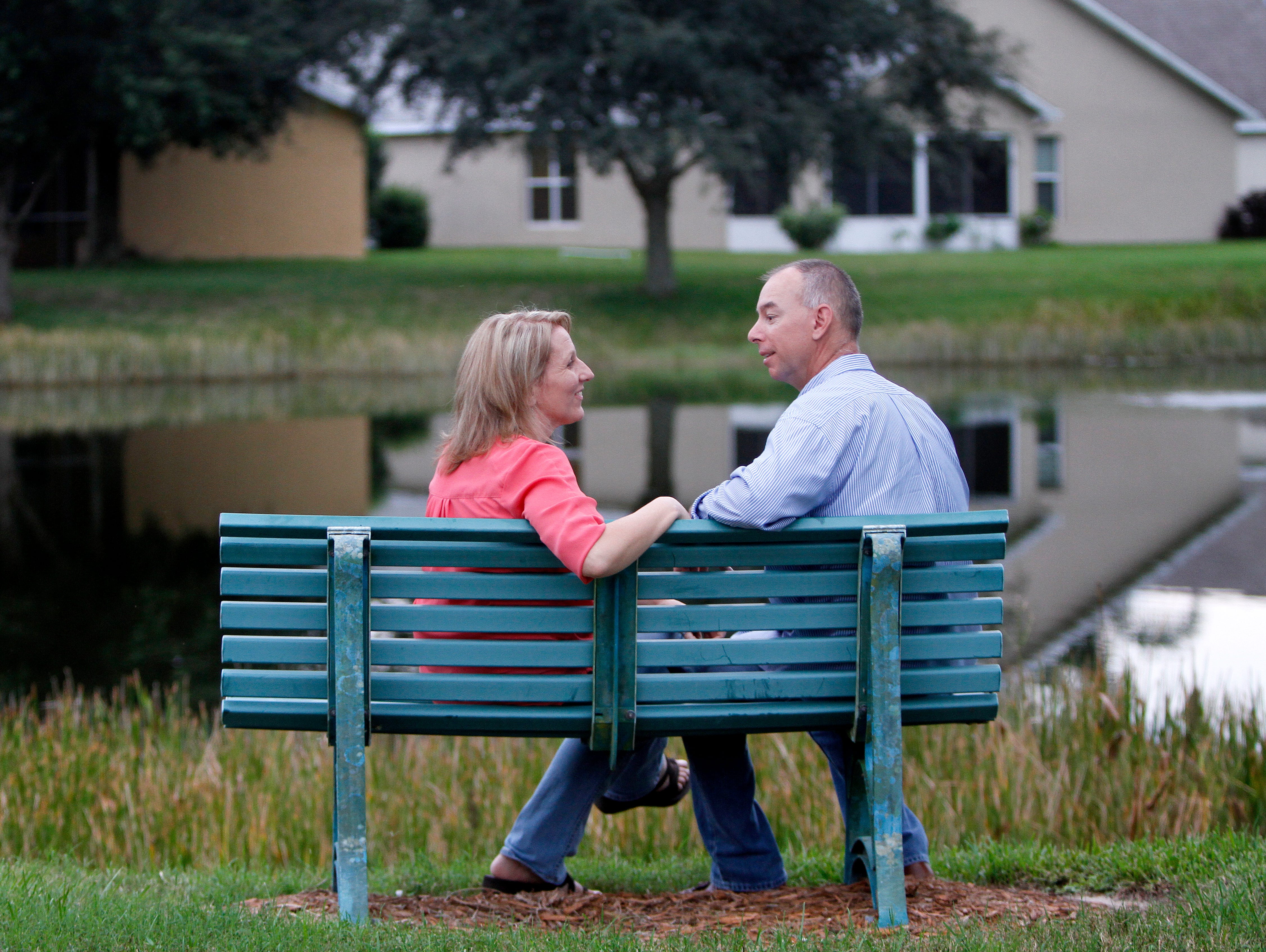 Paul Johnson and Shelly Osterhout, pictured Monday, September 28 sitting on the neighborhood bench where Paul proposed,  are inviting the public to crash their October 10 wedding reception at the Bell Tower Shops.
