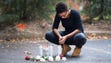 Whitney Skillen prays over a memorial at the location