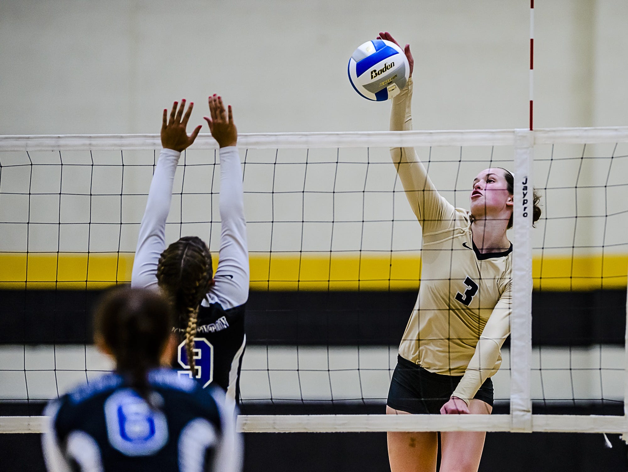Meredith Norris, 3, of Corunna hits over a Lake Fenton block in the third set of their match on September 13, 2016 in Corunna. Norris, who was named Miss Volleyball, is one of three finalists for the State Journal's player of the year.