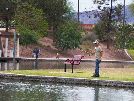 Nathan Foreman, of Queen Creek, fishes at Kiwanis Park