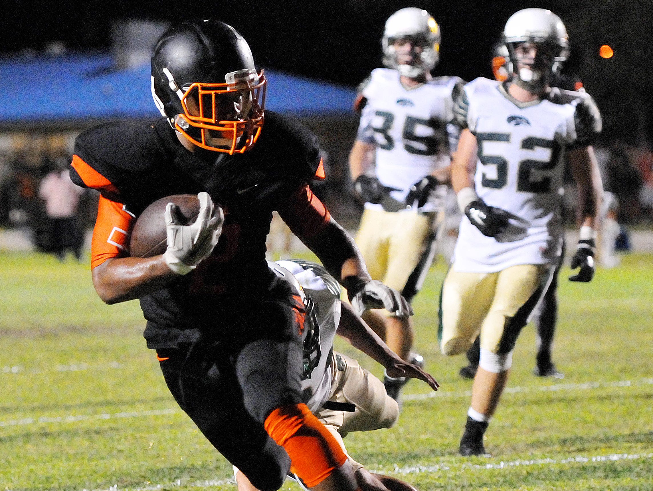 Cocoa Highs #2 Timmy Pratt scores a touch down during Friday nights game against Cocoa High held at Tiger Stadium .