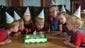 Blowing out the candles on their 4th birthday cake