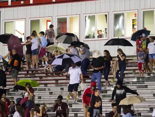 Fans leave the stands after a lightning delay was called before the start of the Riverdale vs. North Fort Myers high school football game on Friday night. The game was already delayed an hour and a half due to lightning.