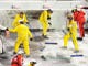 Safety workers clean up the track with Tide laundry detergent after a jet-fueled track dryer burst into flames when it was struck by Juan Pablo Montoya's car under caution during the 2012 Daytona 500.
