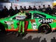 Danica Patrick poses with the pole winner sign after becoming the first woman to win the Daytona 500 pole position on Feb. 17, 2013.