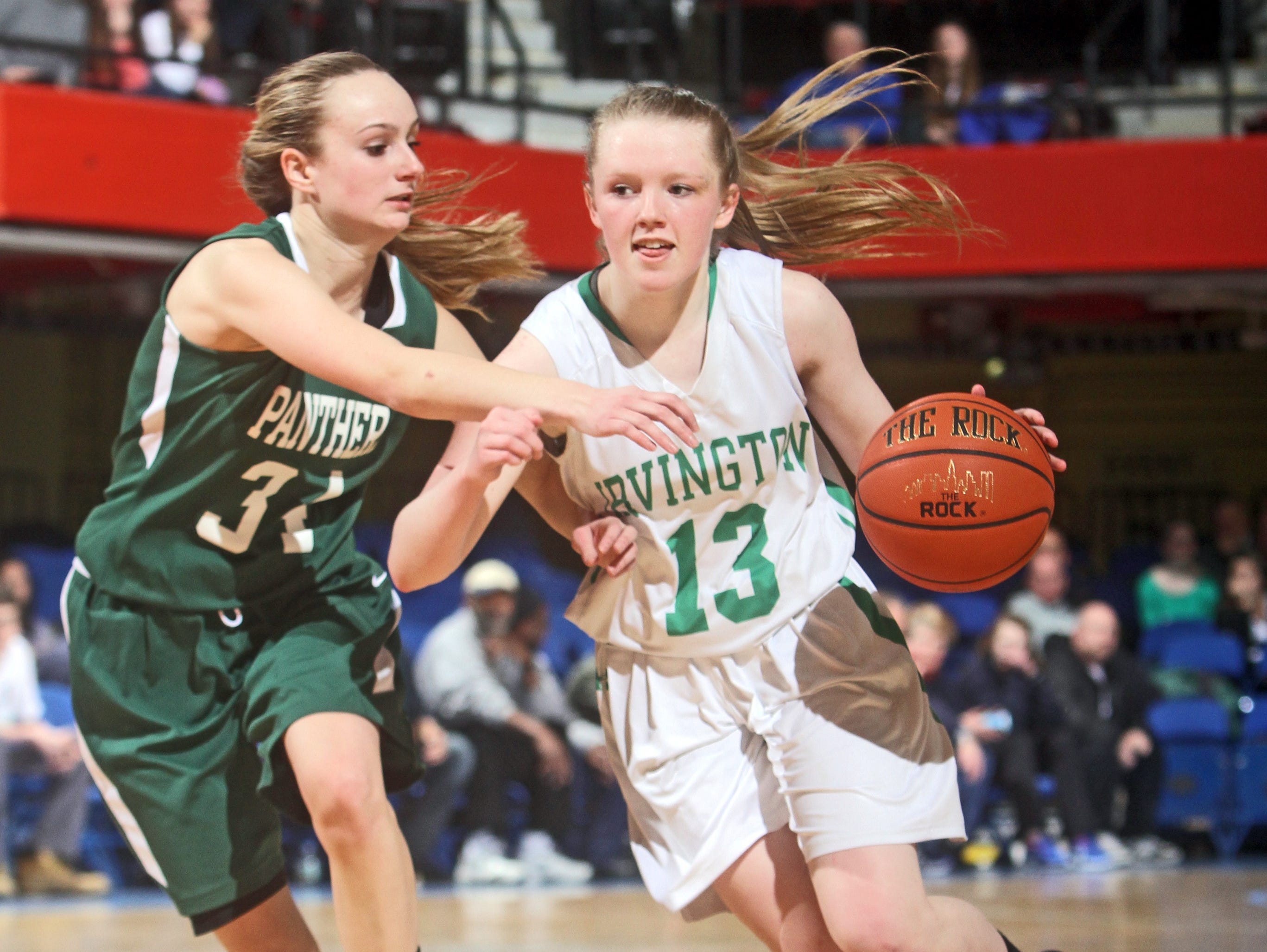 Lindsay Halpin drives on Pleasantville's Annmarie DiCarlo as Irvington defeated Pleasantville 61-39 in a Class B girls basketball semifinal against Pleasantville at the Westchester County Center Feb. 24, 2015. Halpin finished with seventeen points.