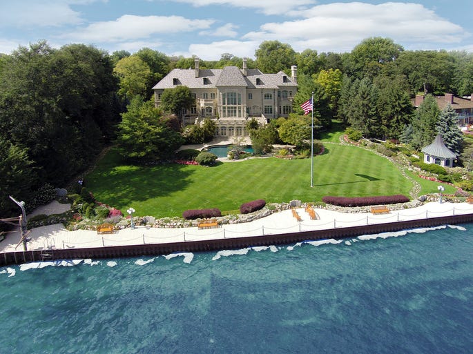 The Lake St. Clair-facing rear view and back yard of the Art Van Elslander estate in Grosse Pointe Shores.  The estate of the Art Van Furniture founder and his wife, Mary Ann, is up for auction. It was initially listed for $15.9 million on the Grand Estates Auction Co. website.