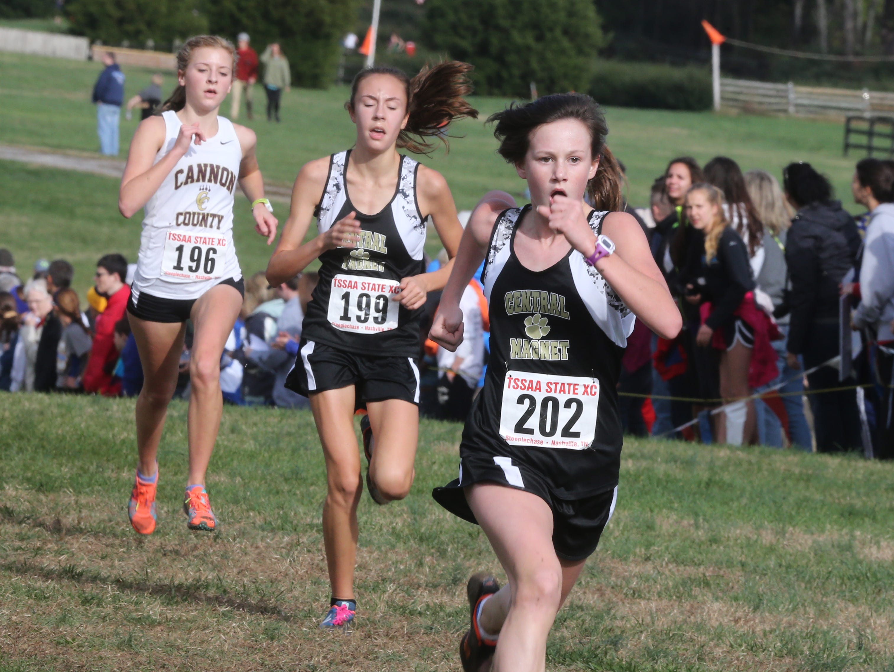 Central Magnet's Caroline Smith, Morgan Ouellette and Cannon County's Hannah Whited sprint to the finish line at the Class A/AA state meet on Saturday. Smith was 24th (21:24.19), Ouellette was 25th (21:26.74) and Whited was 26th (21:27.64).