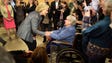 Clinton greets June Whitcomb after a roundtable on