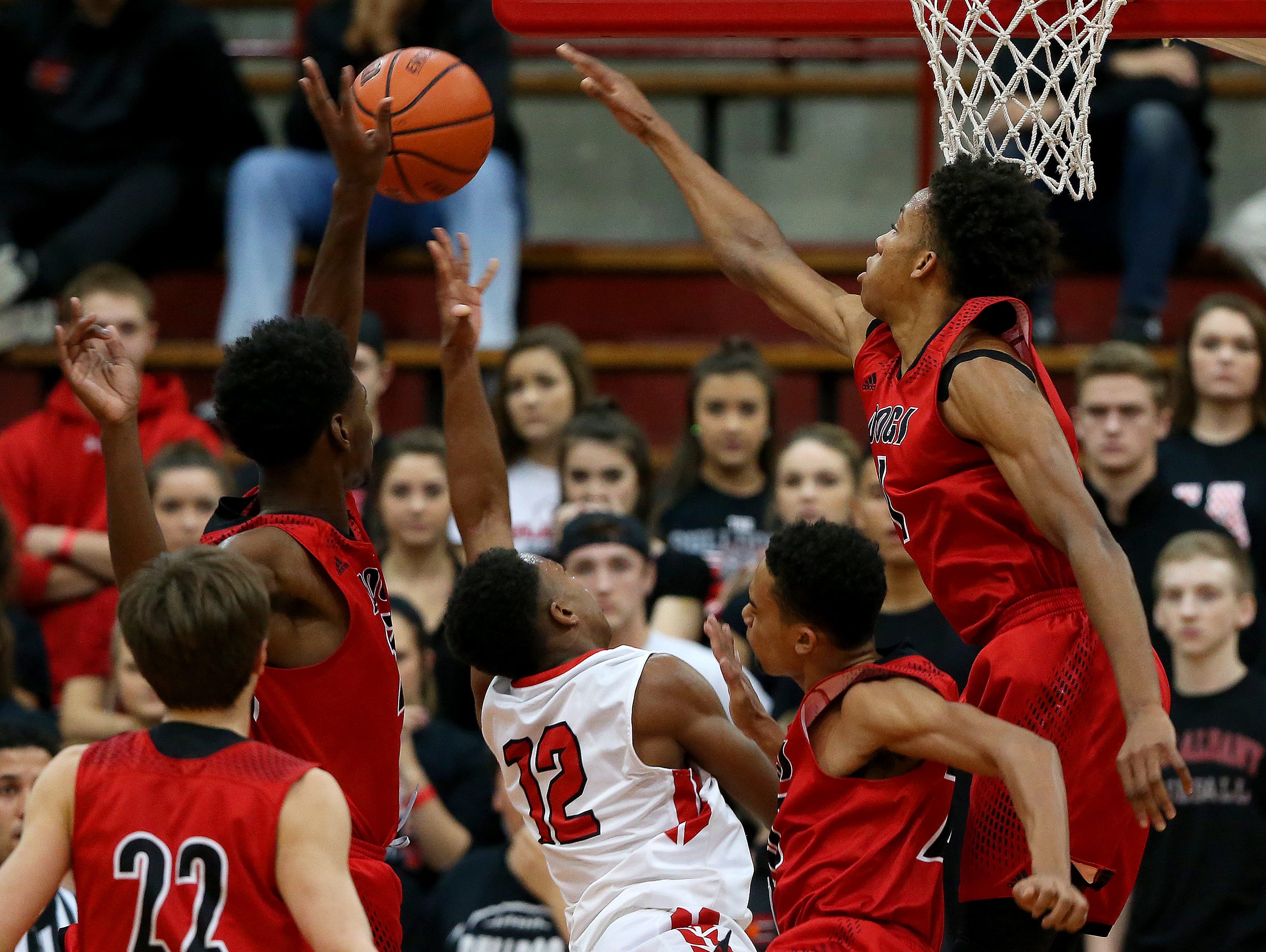 New Albany's Romeo Langford (right) blocked a shot by Pike's Justin Thomas (12) during the Tip Off Classic in December.