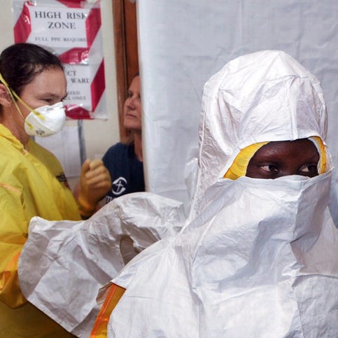 A picture taken on July 24, 2014 shows staff of the Christian charity Samaritan's Purse putting on protective gear in the ELWA hospital in the Liberian capital Monrovia.