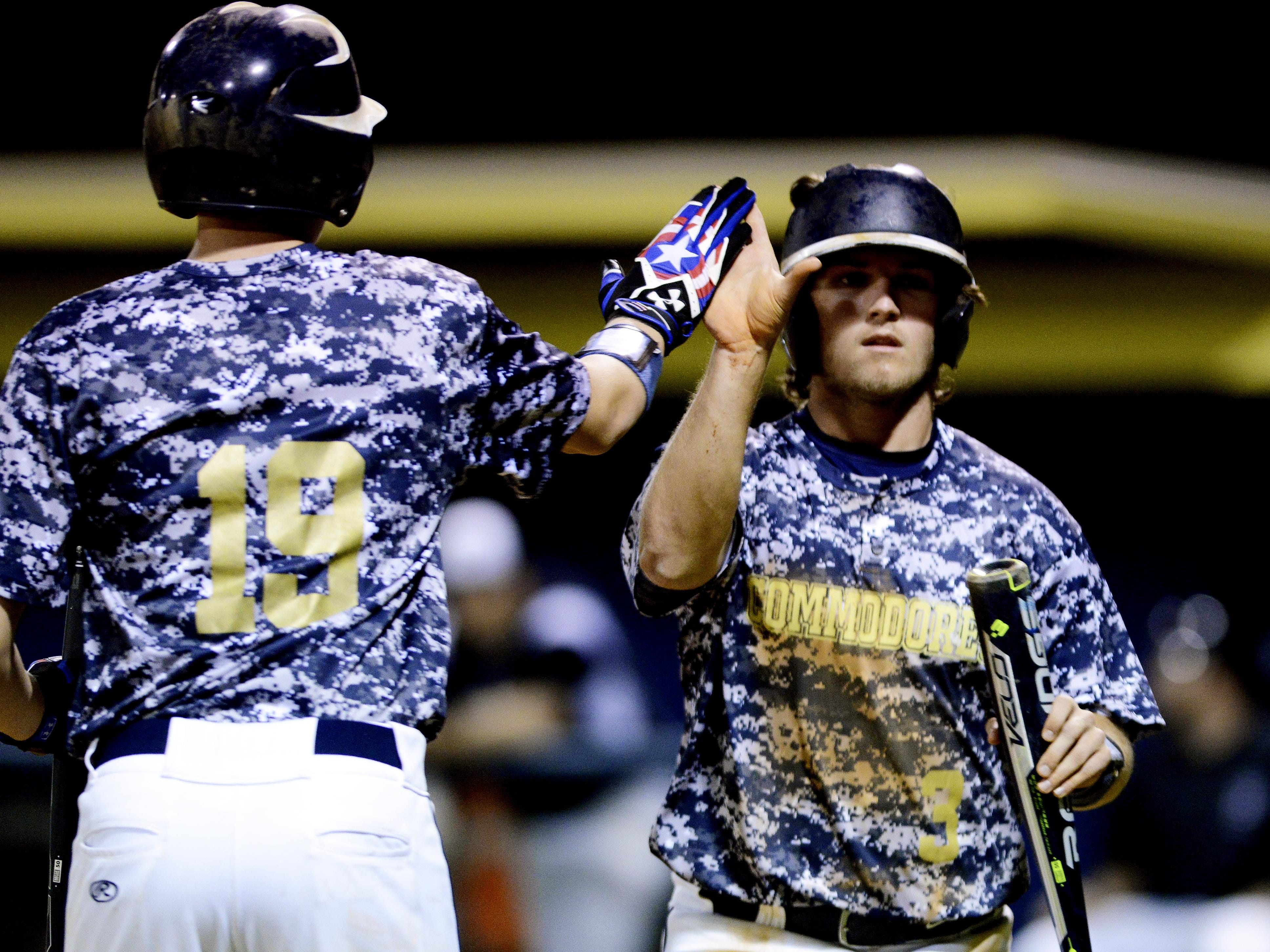 Eau Gallie's Johnny Amber (3) high fives teammate Jacob Teter after scoring in Wednesday's game against Palm Bay.