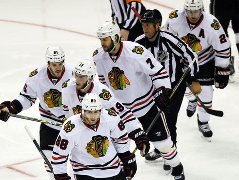 Chicago Blackhawks right wing Patrick Kane (88) skates back towards the bench with his linemates after scoring a goal during the second period.