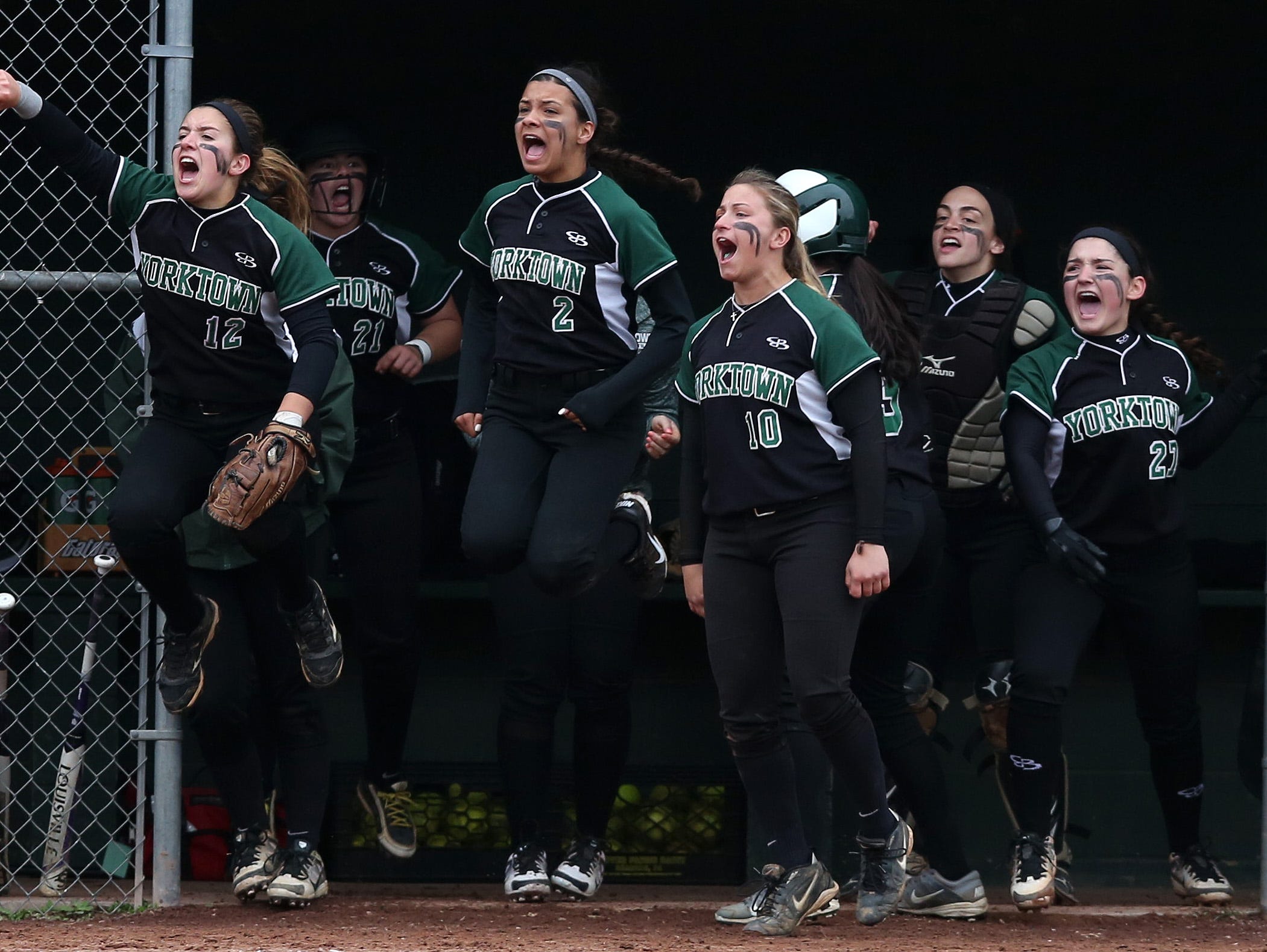 Yorktown players celebrate a run during a seventh inning rally against Brewster in a girls softball game at Brewster High School May 5, 2016. Yorktown won the game 6-4.