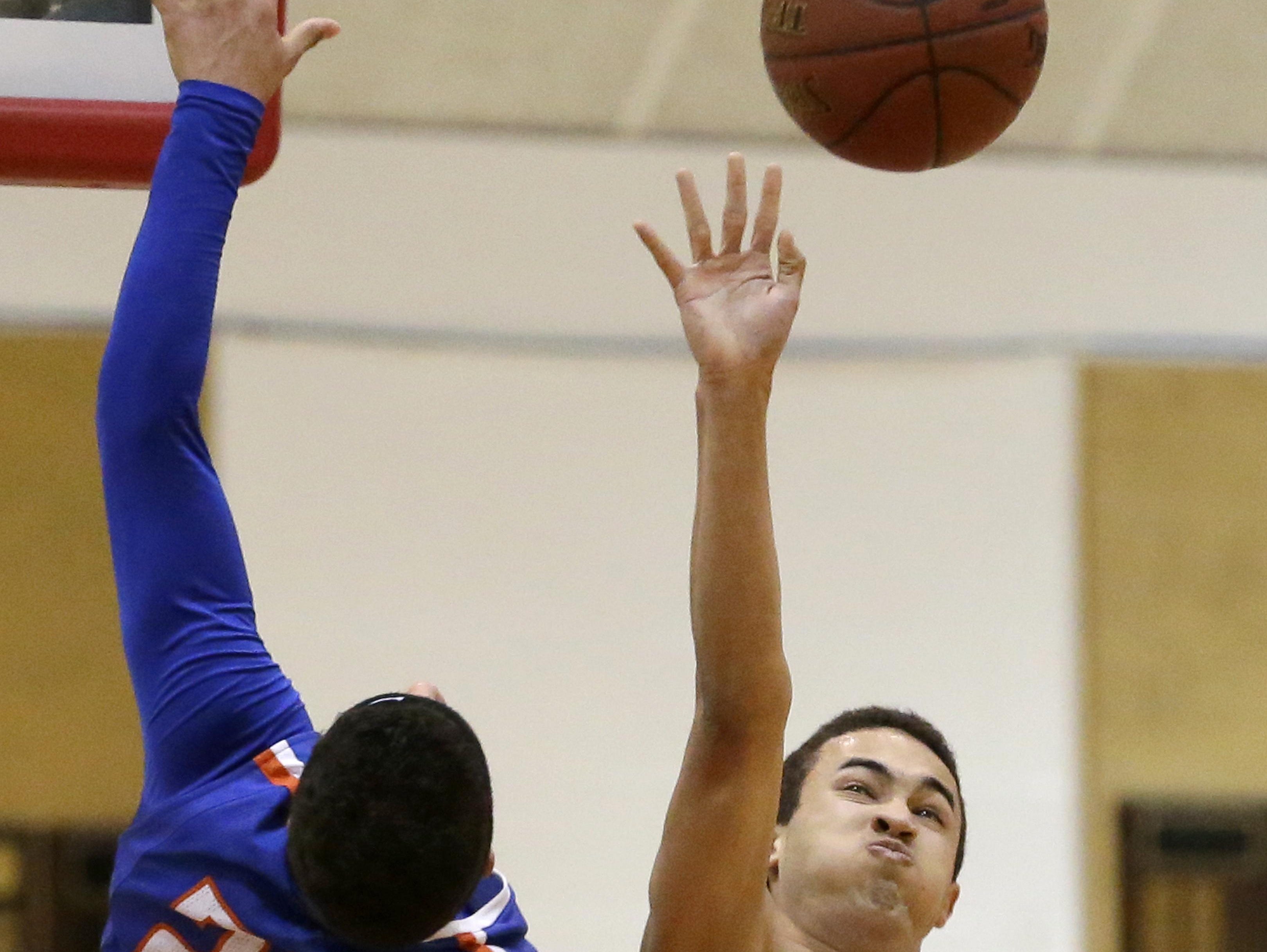 Neenah’s Zavier Sims (right) knocks the ball away from Appleton West’s Jeason Thomas during Friday’s game in Neenah.
