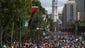 People gather along Benjamin Franklin Parkway as they