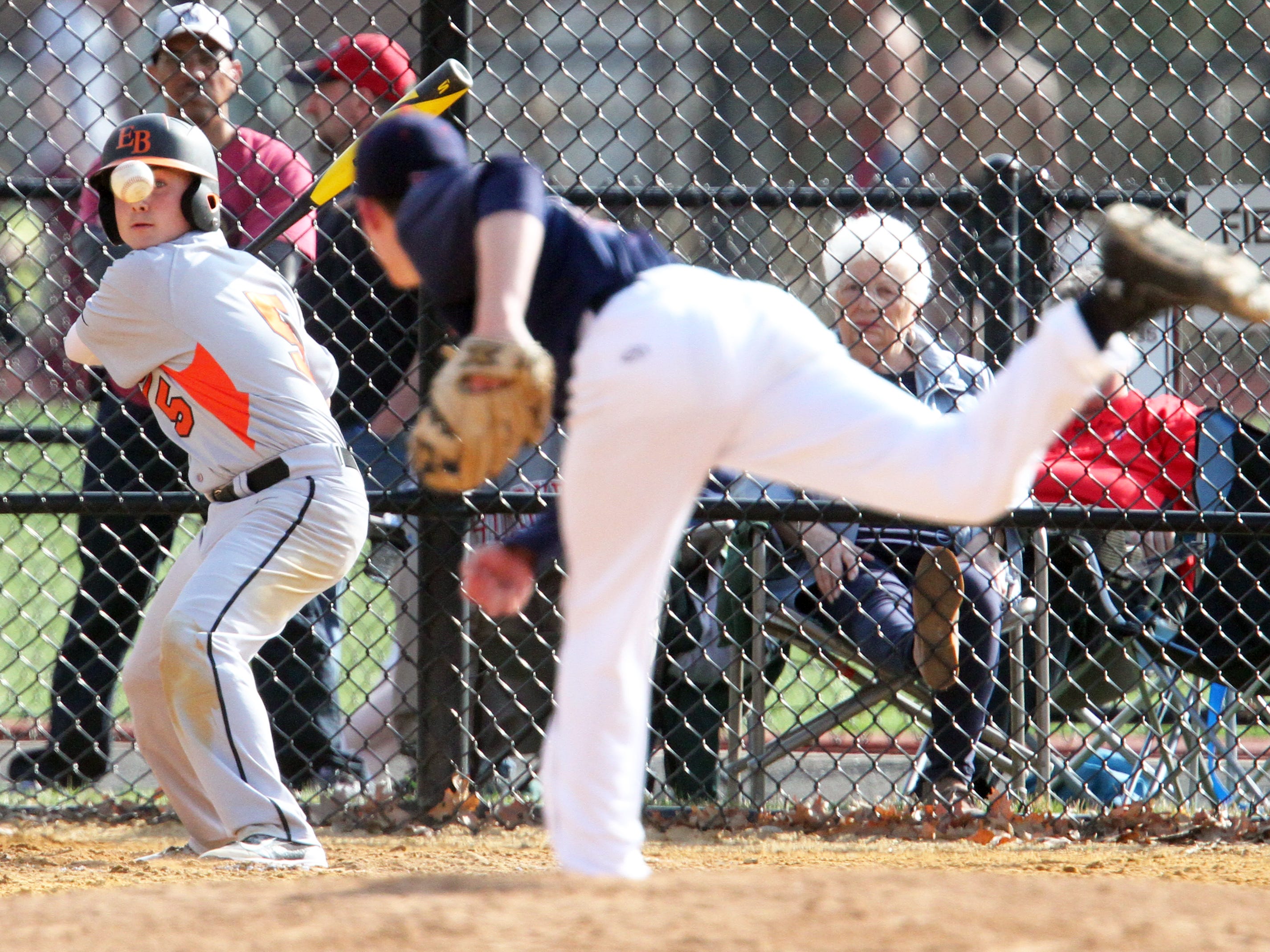 Dunellen takes on East Brunswick Tech in a varsity baseball game in Dunellen on Friday April 17,2015. Batter # 5 (left) East Brunswick's # 5 Vincent Pellicane keeps his eye on the ball as Dunelle pitcher # 5 (right) David Johnson tries to haul the ball by him.