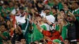Mexican fans cheer for their team against New Zealand