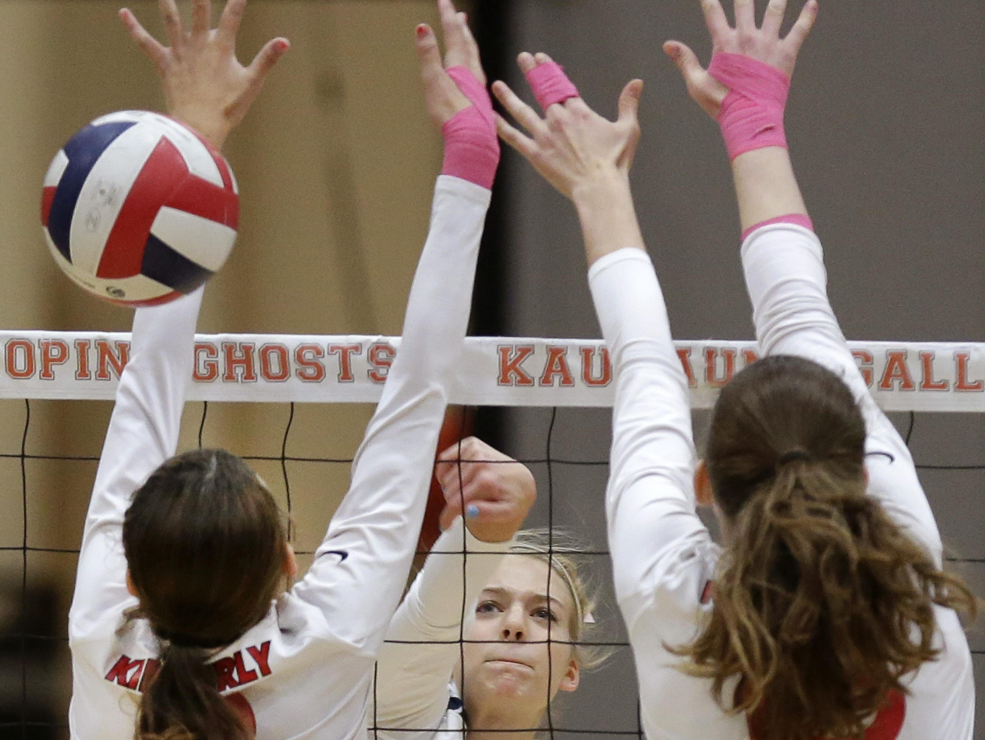 Appleton North’s Cami Phillips (center) spikes through the defense of Kimberly during Thursday’s match in Kaukauna.