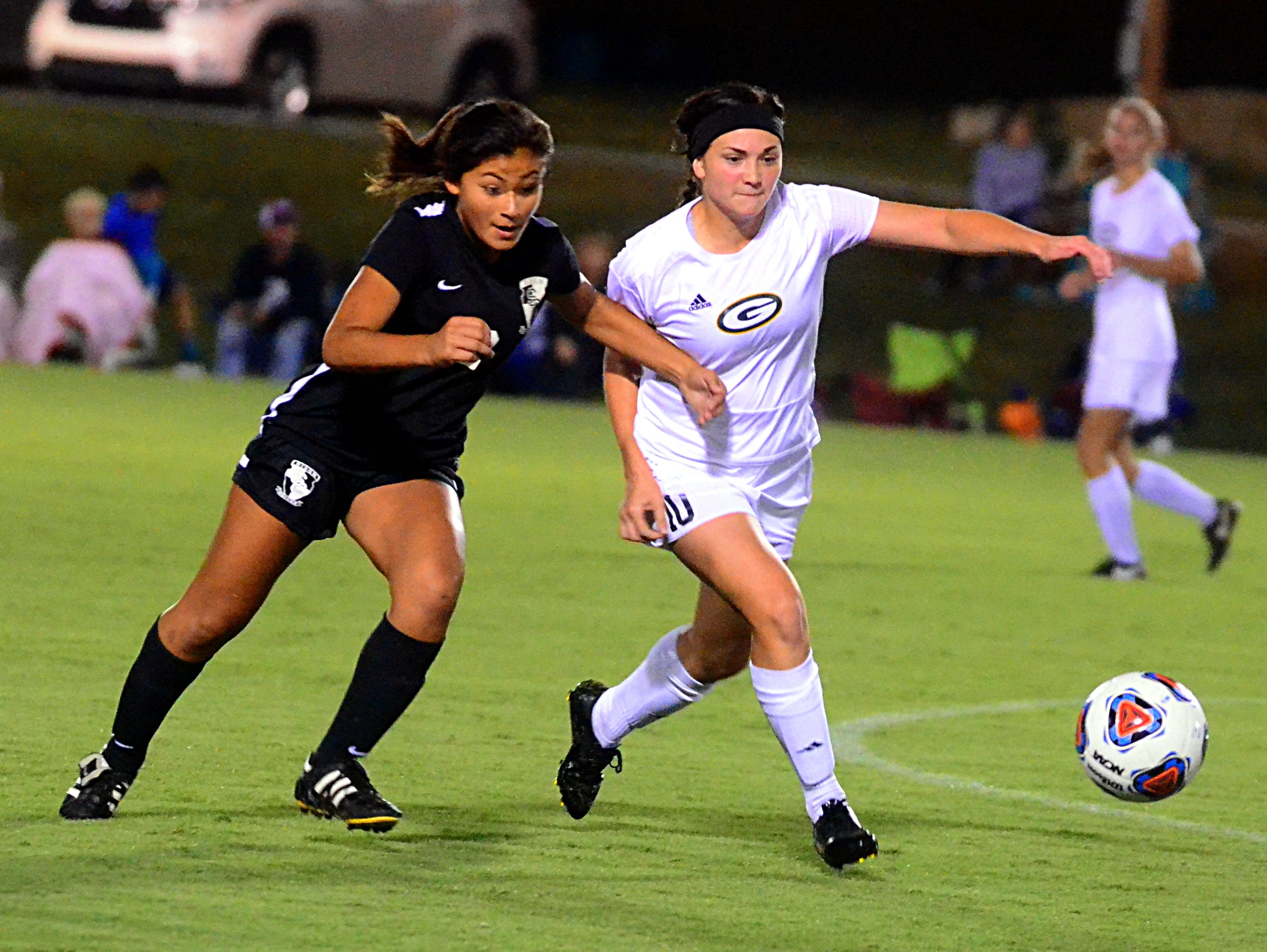 Station Camp junior Ariana Orellana (left) and Gallatin senior Veda Hooge battle for a loose ball during Thursday's match. Orellana scored a goal in the Lady Bison's 2-0 victory.