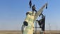 Militants wave the Islamic State flag from a damaged government fighter jet after they captured the Tabqa air base.