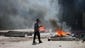 A Muslim Brotherhood supporter passes fires as demonstrators battle police at Ramses Square.