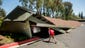 A boy examines cars trapped beneath a collapsed carport at Charter Oaks apartments in Napa, Calif., following an earthquake.