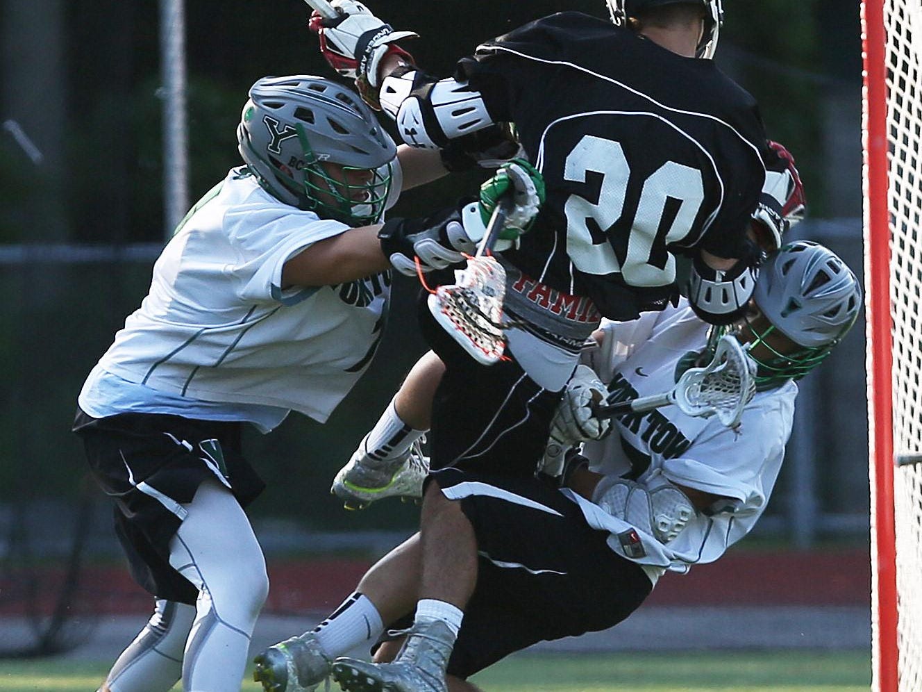 From left, Yorktown's Ryan Cegielski (1) and Nick Sanfardino (7) combine to stop Albany Academy's Maurice Tessier (20) from getting to the goal during a Class B regional playoff game at Lakeland High School in Shrub Oak Saturday.