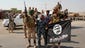 Shiite militia fighters hold a captured Islamic State flag on Sept. 1 outside Amirli, Iraq.