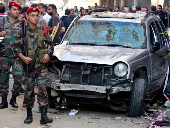 Lebanese army soldiers stand guard near the damaged