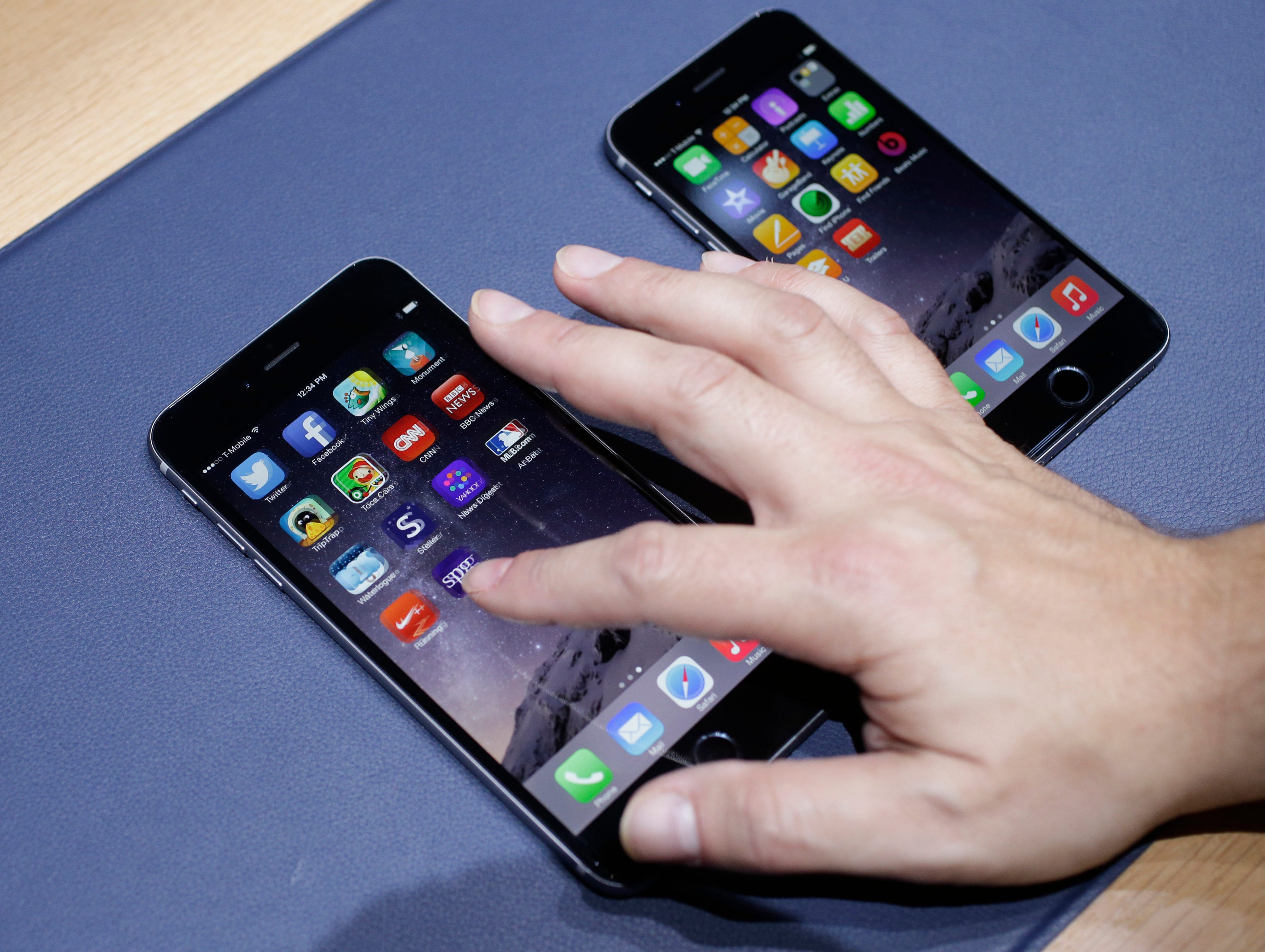 The iPhone 6 Plus, at left, and iPhone 6 are displayed on Tuesday, Sept. 9, 2014, in Cupertino, Calif.
