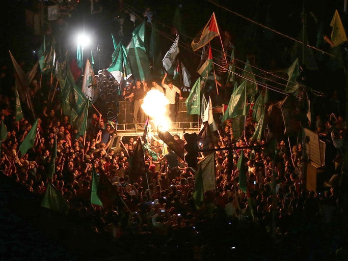 Palestinians celebrate the announcement of a cease-fire on Aug. 26 in Gaza City. Palestinian President Mahmoud Abbas announced an Egyptian-brokered cease-fire proposal to end seven weeks of fighting between Israel and militant groups in the Gaza Strip.