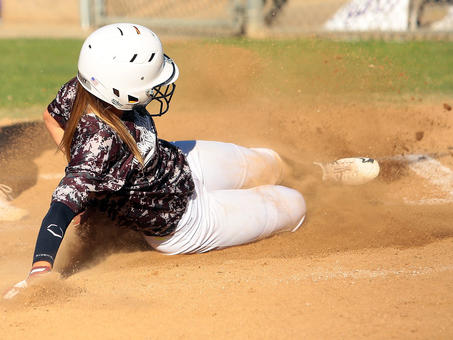 La Quinta's Hanna Zanesco (12) slides into to home plate and scores against Shadow Hills during the fifth inning of an afternoon game Thursday. The schools played a double header and La Quinta won the first game 7-5 and the second 4-1.
