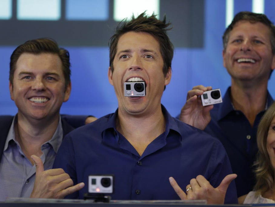 GoPro's CEO Nick Woodman holds a GoPro camera in his mouth as he celebrates his company's IPO at the Nasdaq MarketSite in New York, Thursday, June 26, 2014. GoPro, the maker of wearable sports cameras, loved by mountain climbers, divers, surfers and 