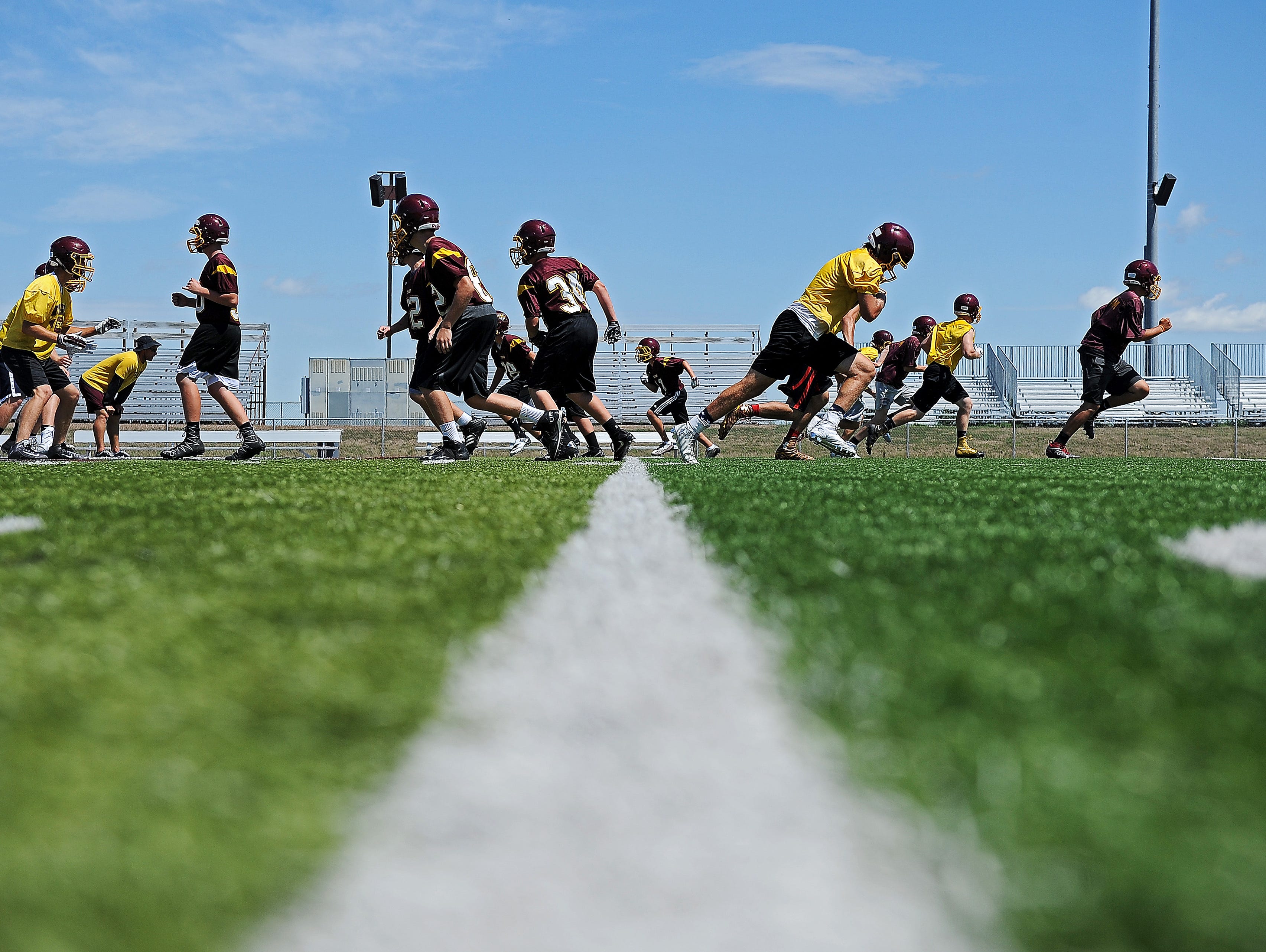 Harrisburg High School football players run through a drill during a practice Tuesday, Aug. 16, 2016, at the Harrisburg High School in Harrisburg, S.D.