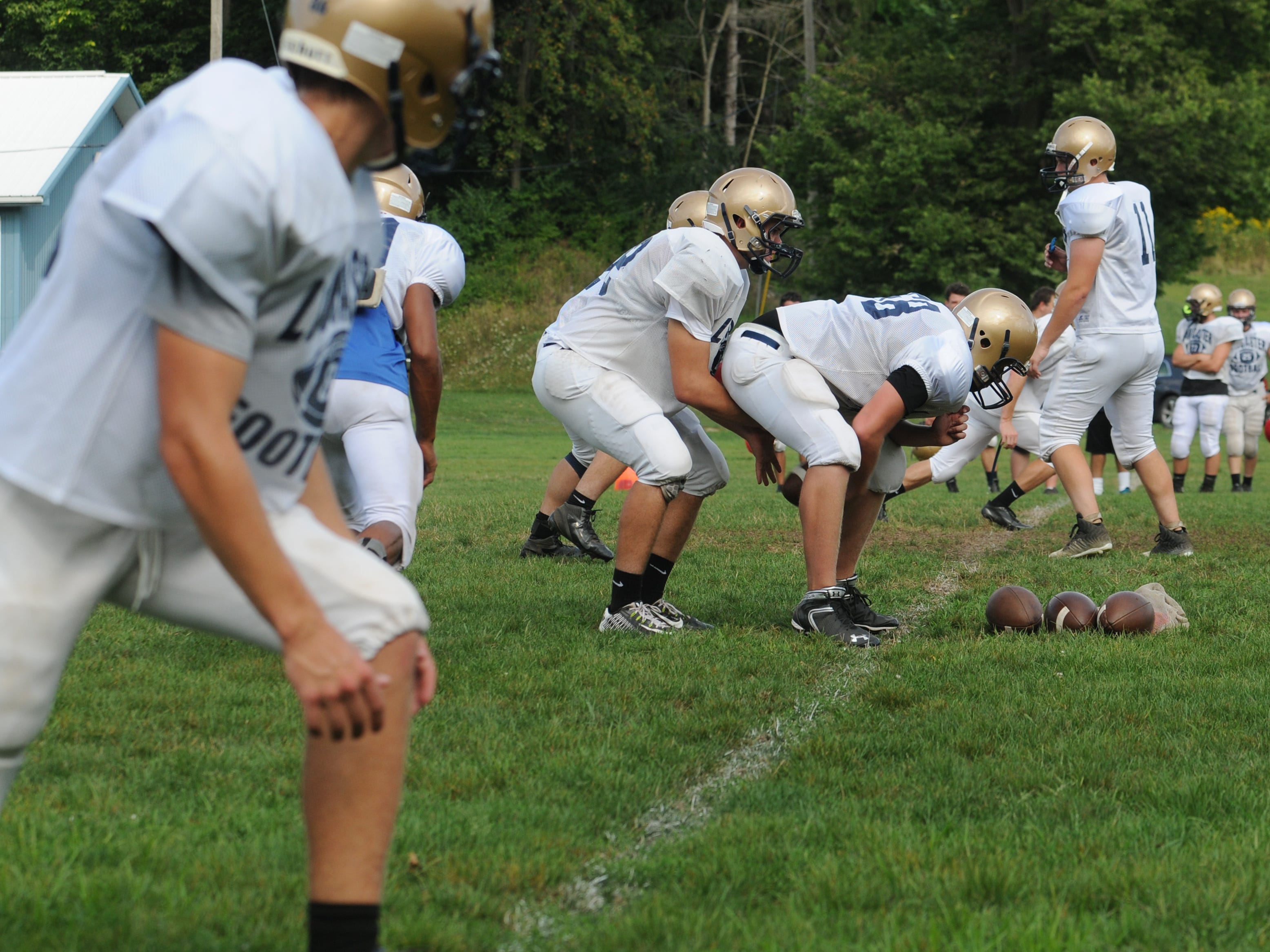  The Lancaster football team lines up to run a play during Monday’s practice. 