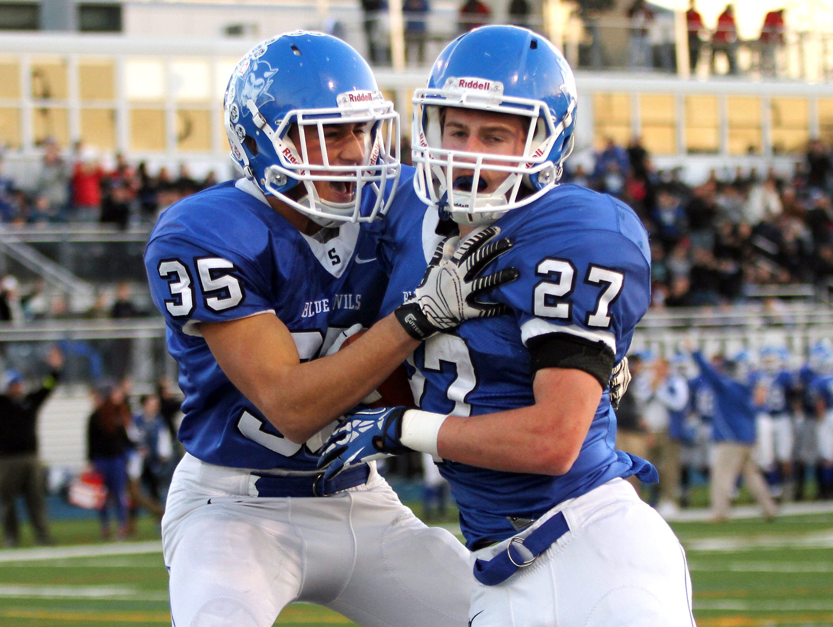 Shore Regional's Duke Russo, l, celebrates with running back Jack Britton after Britton's score in the first half Palmyra in the NJSIAA Central, Group 1 Championship game at Kean University Alumni Stadium. December 5, 2015, Union, NJ.