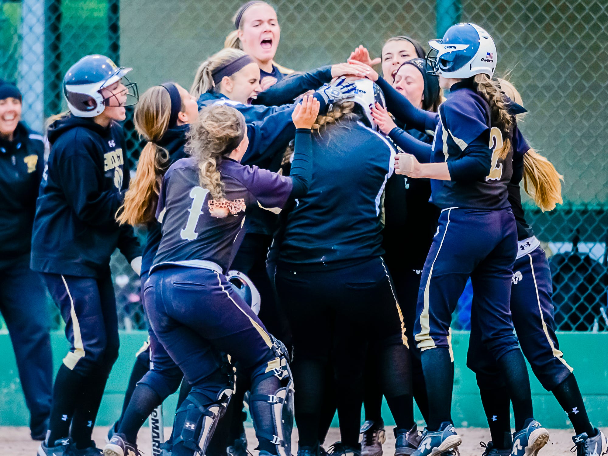 Mackinley Lane ,center, of Holt is congratulated by her teammates after hitting a 2-run homer in the 3rd inning of their Softball Classic championship game with St. Johns Tuesday May 19, 2015 at Ranney Park in Lansing. KEVIN W. FOWLER PHOTO