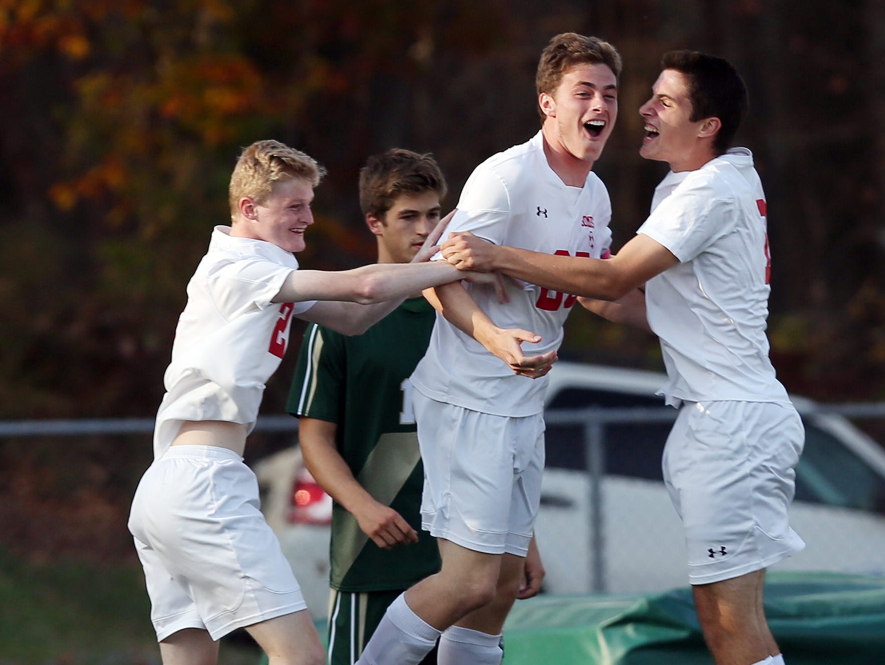 Somers Evan Kieltyka (25) celebrates his first half goal with teammates Jake Faigle (2) and Max Grell (19) against Vestal during the boys soccer regional semifinal at Lakeland High School in Shrub Oak Nov. 2, 2016. Somers won the game 3-0.