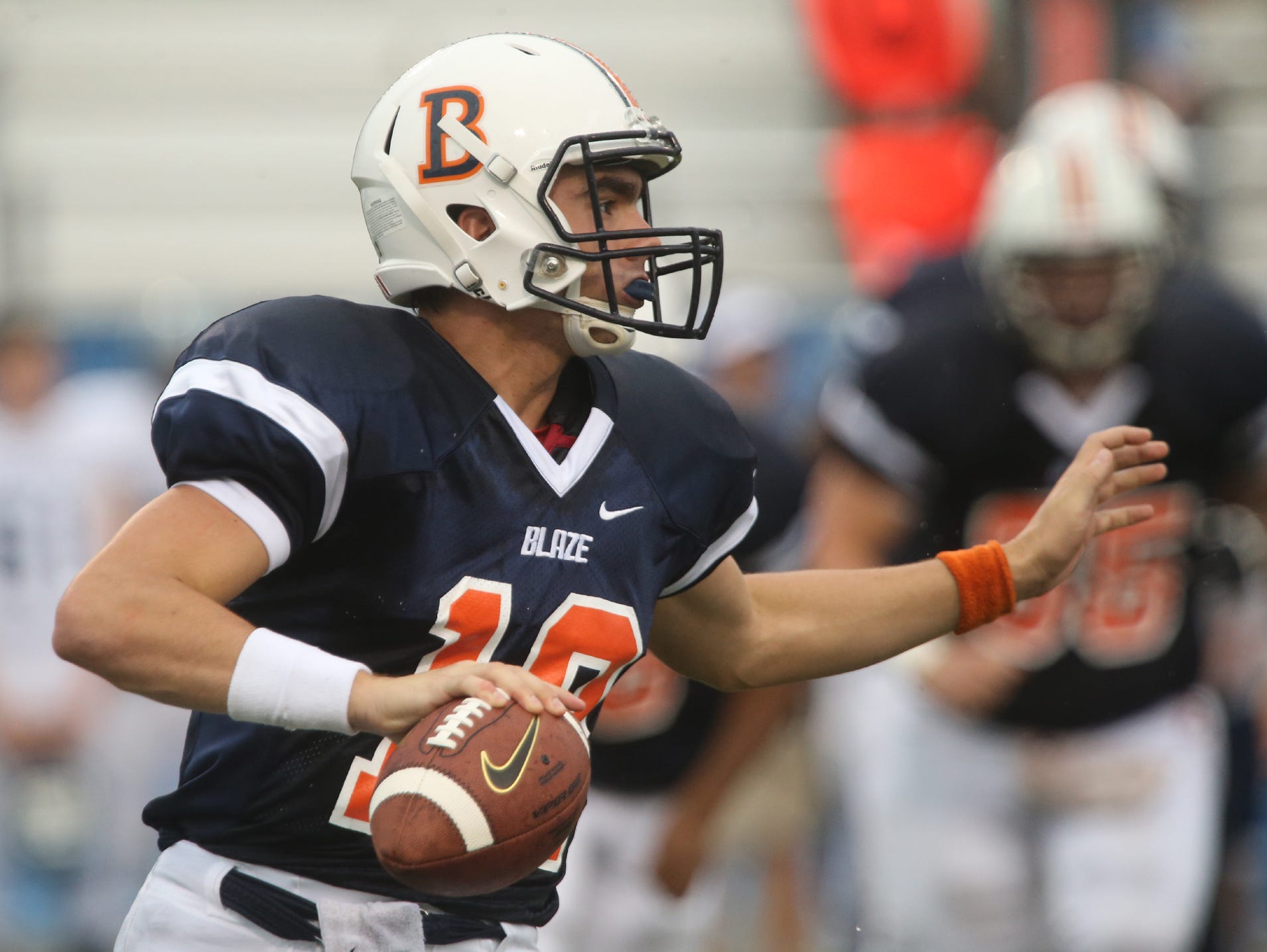 Blackman's quaterback Miller Armstrong scrambles in the backfield looking for a receiver during the first game of the Middle Tennessee Classic against Chalkville at MTSU's Floyd Stadium Saturday, Aug. 22, 2015.