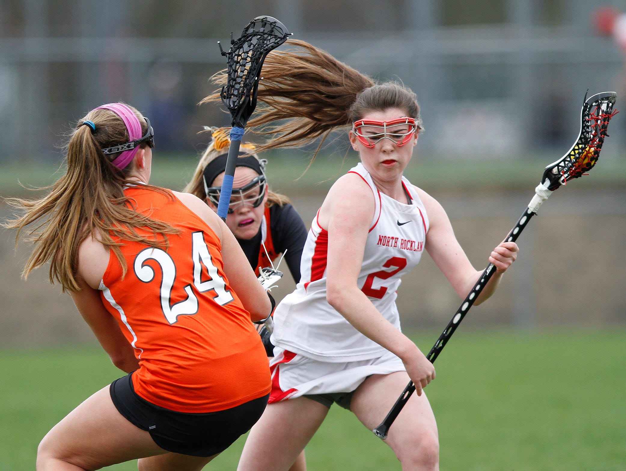 North Rockland's Elizabeth Fox (2) works the ball around Mamaroneck's Cassie Budill (24) during a girls lacrosse game at North Rockland High School in Thiells on Saturday, April 02, 2016.